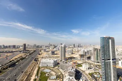 an aerial view of a city with buildings and roads at Stylish Studio Apartment Skyz by Danube in Dubai