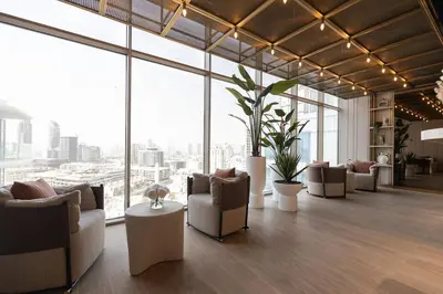 a lobby with couches and tables and large windows at Gracious Studio in Pearl House by Imtiaz in Dubai
