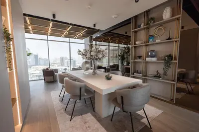 a dining room with a white table and chairs at Gracious Studio in Pearl House by Imtiaz in Dubai