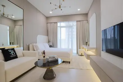 a living room with a couch and a table at Gracious Studio in Pearl House by Imtiaz in Dubai