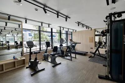 a gym with treadmills and ellipticals in a room at Prime 2BR in Binghatti Crest - JVC in Dubai