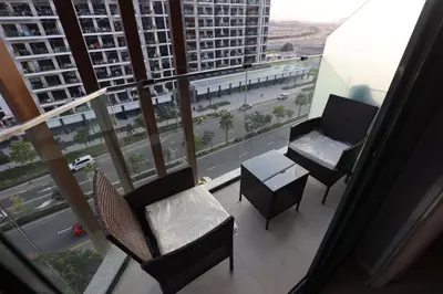 a balcony with chairs and a table in a building at Modern and cozy studio apartment in Dubai