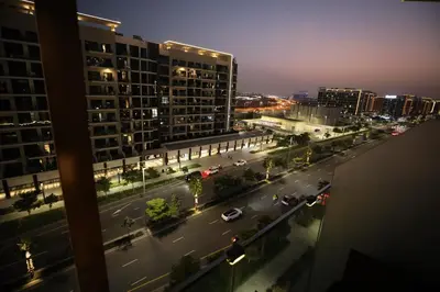 a view of a city street at night with buildings at Modern and cozy studio apartment in Dubai