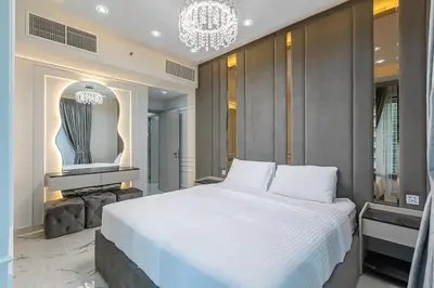 a bedroom with a large white bed and a chandelier at Spacious 2 BDR apartment in Downtown Dubai I 29 Blvd in Dubai