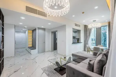 a living room with a couch and a chandelier at Spacious 2 BDR apartment in Downtown Dubai I 29 Blvd in Dubai