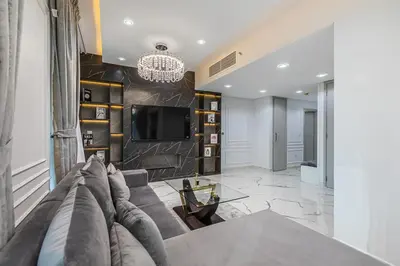 a living room with a couch and a tv at Spacious 2 BDR apartment in Downtown Dubai I 29 Blvd in Dubai
