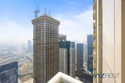 a tall building with a crane on top of it at Salt & Sand Hamptons Glow 2BR Sulafa Tower in Dubai