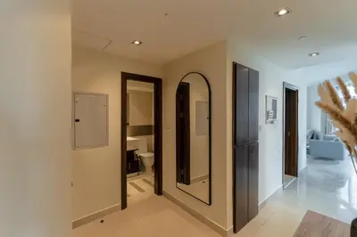 a hallway with a mirror and a bathroom at Spacious - Stylish - Scenic Marina View in Dubai
