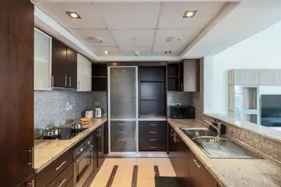 a large kitchen with wooden cabinets and stainless steel appliances at Spacious - Stylish - Scenic Marina View in Dubai
