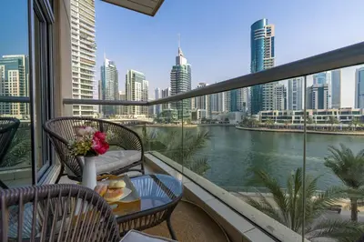 a balcony with a view of a river and buildings at Spacious - Stylish - Scenic Marina View in Dubai