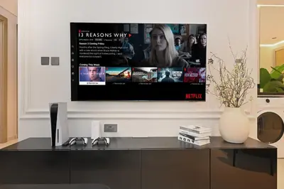 a flat screen tv sitting on top of a cabinet at High Floor 2 Bedroom Apartment - Exclusive Luxury at Aykon Tower - PlayStation 5 in Dubai