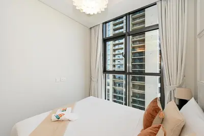 a white room with a large window and a bed at High Floor 2 Bedroom Apartment - Exclusive Luxury at Aykon Tower - PlayStation 5 in Dubai