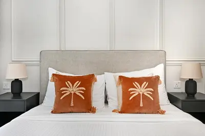 a bedroom with a bed with two lamps and two pillows at High Floor 2 Bedroom Apartment - Exclusive Luxury at Aykon Tower - PlayStation 5 in Dubai