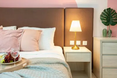 a bedroom with a bed with a bowl of fruit and a lamp at Luxury Studio with Private Beach Access - Palm Jumeirah in Dubai
