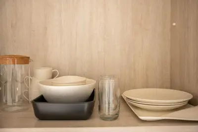 a counter with bowls and plates on a table at Luxury Studio with Private Beach Access - Palm Jumeirah in Dubai