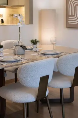 a dining room table and chairs with plates and wine glasses at Newly Upgraded 2BR - Steps from Burj Khalifa and Opera in Dubai