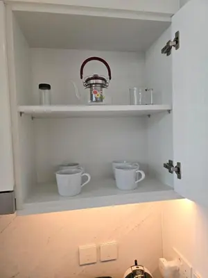 a shelf with two cups and a pot on it at Luxury 1BR with Scenic Views - Palace Residence in Dubai