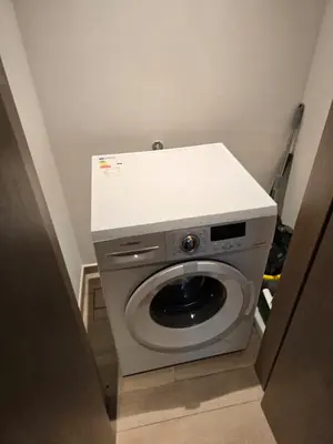a washing machine with a white top in a room at Luxury 1BR with Scenic Views - Palace Residence in Dubai