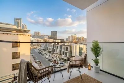 a balcony with a view of a city at Binghatti Phoenix! Longest Pool in Dubai! Brand New Building, 2 Double Beds! in Dubai