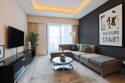 a living room with a couch and a tv at 904 DAMAC Paramount in Dubai
