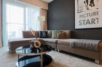 a living room with a couch and a glass table at 904 DAMAC Paramount in Dubai