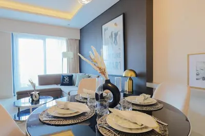 a living room with a dining room table with chairs at 904 DAMAC Paramount in Dubai