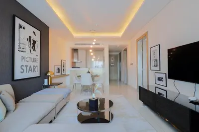 a living room with a couch and a tv at 904 DAMAC Paramount in Dubai