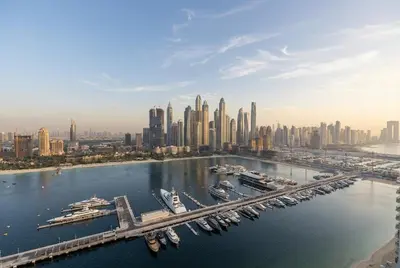 an aerial view of a city with a harbor with boats at Lux 2BR Beachfront Escape Palace Beach Residence in Dubai