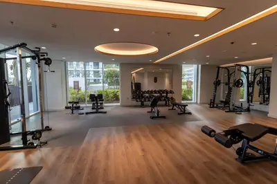 a gym with treadmills and weights in a building at Lux 2BR Beachfront Escape Palace Beach Residence in Dubai