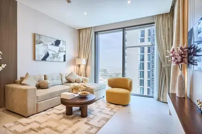 a living room with a couch and a chair at STAY BY LATINEM Luxury 1BR Holiday Home CVG2403 Near Downtown in Dubai