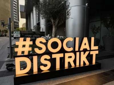 a sign for a social district in front of a building at Ultra Luxury 4BR 7P Burj and Fountain View in Dubai