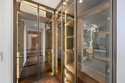 a walk in closet with glass doors at Ultra Luxury 4BR 7P Burj and Fountain View in Dubai