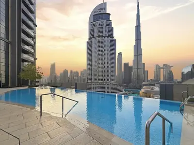 a swimming pool on the roof of a building with a city at Ultra Luxury 4BR 7P Burj and Fountain View in Dubai