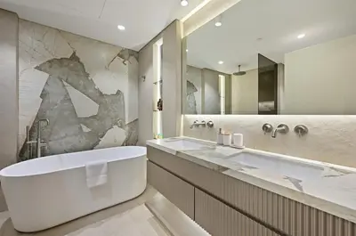 a bathroom with a large tub and a large mirror at Ultra Luxury 4BR 7P Burj and Fountain View in Dubai