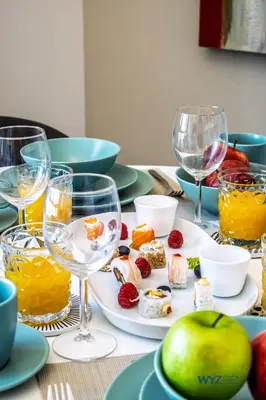 a table with plates of food and wine glasses at Upscale 1BR Loft Central Walk to Burj Khalifa&Mall in Dubai