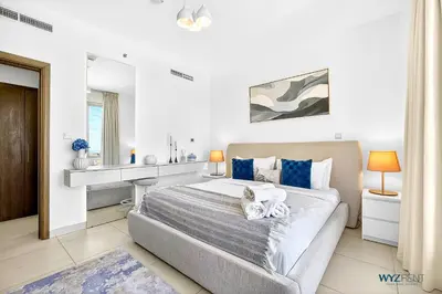 a bedroom with a bed with two teddy bears on it at Upscale 1BR Loft Central Walk to Burj Khalifa&Mall in Dubai