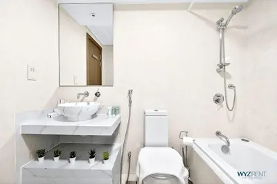 a white bathroom with a sink and a toilet at Upscale 1BR Loft Central Walk to Burj Khalifa&Mall in Dubai