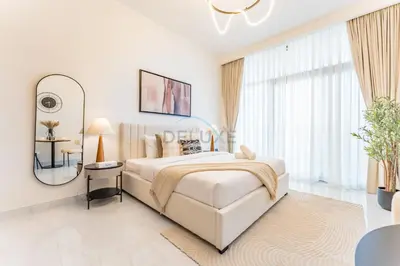 a white bedroom with a large bed and a mirror at Just Minutes Drive From Dubai Autodrome, Conveniently Located Within A Short Walk Of The Bus Stop, Azizi Vista, Dubai Studio City by Deluxe Holiday Homes in Dubai
