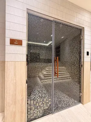 a glass door in a building with stairs behind it at Luxury Apartment in JVC with Private Balcony Pool in Dubai
