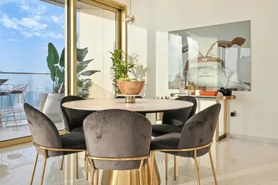 a dining room with a table and chairs at BLVD Beachfront Living with Skyline View in Dubai
