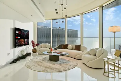 a living room with couches and a table at BLVD Beachfront Living with Skyline View in Dubai