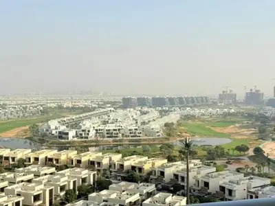 an aerial view of a city with white buildings at Mahenti - Stunning Golf View Studio in Damac Hills in Dubai
