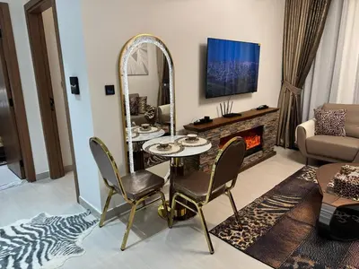 a living room with a table and a mirror at Luxury Skyline View Apartment - Binghatti Tulip 1401 in Dubai