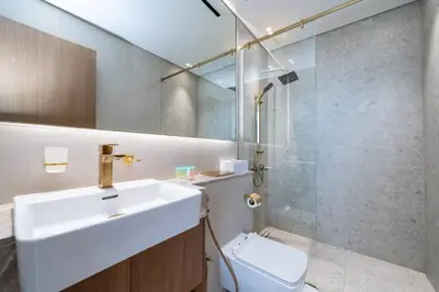 a bathroom with a sink and a shower and a toilet at High Floor JVC 1BR Skyline Showstopper in Dubai