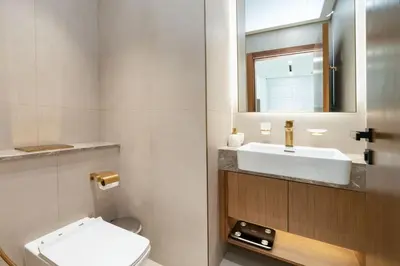 a bathroom with a white toilet and a sink at High Floor JVC 1BR Skyline Showstopper in Dubai