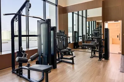 a gym with a row of treadmills and machines at High Floor JVC 1BR Skyline Showstopper in Dubai