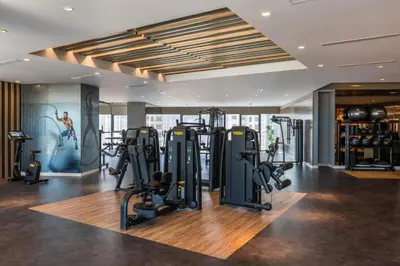 a gym with several treadmills and exercise bikes at Luxury 2BR - Paramount Midtown with Infinity Pool in Dubai