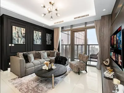 a living room with a couch and a table at Luxury 2BR - Paramount Midtown with Infinity Pool in Dubai