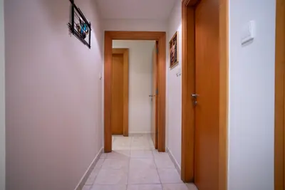 a hallway with two doors and a tile floor at Luxury 2BR Haven with Panoramic Scenery in Dubai