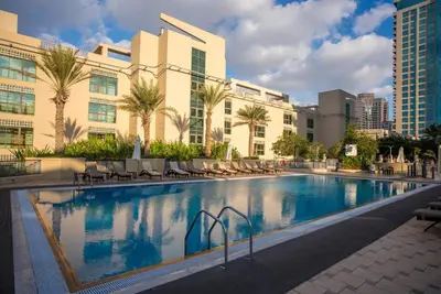 a large swimming pool in front of a building at Luxury 2BR Haven with Panoramic Scenery in Dubai